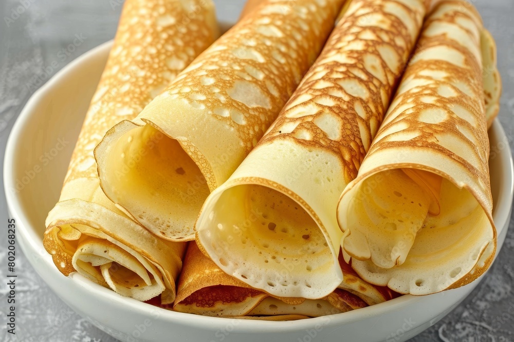 Poster top view of rolled pancakes on light background with ample space for text placement