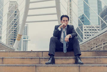 Failure businessman stress bankruptcy man sitting wood desk feeling nagative depression have headache. Men unemployed jobless recession crisis stress lost job. Despair Failure businesspeople concept