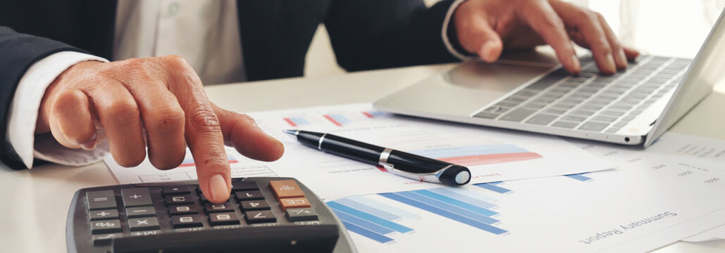 Banner Asian Business man hands using calculator counting tax financial bill. Tax audit Finacial concept. Panorama Close up businessman hands calculating number tax audit planning with copy space