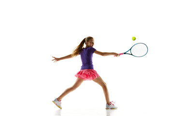 Sportive young girl, tennis athlete in comfortable vibrant uniform playing tennis in motion against white studio background. Concept of professional sport, movement, tournament, action. Ad - Powered by Adobe