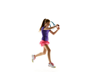 Naklejka premium Sporty young girl, tennis player in uniform ready to hit two-handed backhand stroke in motion against white studio background. Concept of professional sport, movement, tournament, action. Ad