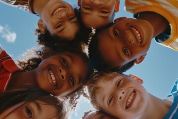 Group of diverse children looking at camera and smiling while standing against blue sky