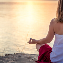 Woman meditating at the sea