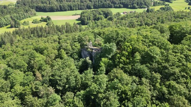 Flight towards ruins of Leienfels Castle and tree panorama near Pottenstein (Franconian Switzerland), Germany