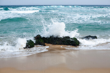 View of the rock and splashing surf at the seaside