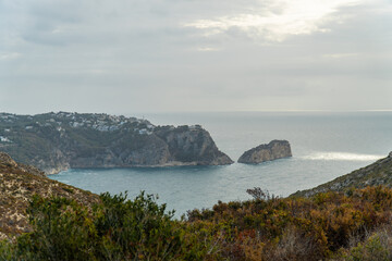 Panoramic view, cliffs and Mediterranean sea on a cloudy morning day, in Jávea, Alicante (Spain).