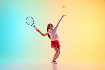 Teenage athlete girl, tennis player serving ball in motion perfectly to start tennis match in neon...