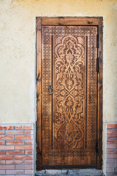 carved wooden door with a oriental Uzbek carved pattern decorated with Islamic ornaments in Uzbekistan in Tashkent