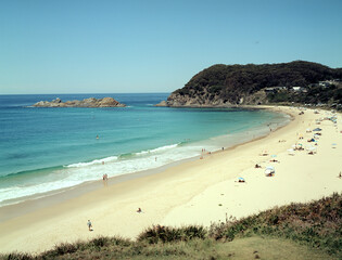 A sandy beach in the summer with people resting there. Medium format film (Kodak Ektar 100) shot...