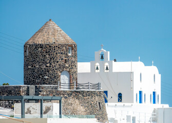 Old wind mill and an orthodox church, Fira, Thira island, Santorini, Cyclades islands, South Aegean...