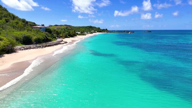 Aerial view of the beautiful Turners Beach at the Caribbean island of Antigua and Barbuda with turquoise sea and fine sand