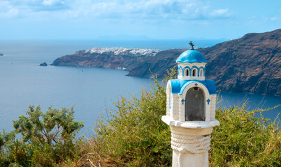 Traditional greek orthodox religious memorial post on the hiking trail to Oia, Thira island,...