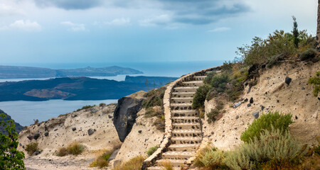 Beutiful curved stone steps on the hiking trail to Oia, Thira island, Santorini, Cyclades islands,...