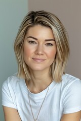 Fototapeta premium Adorable blonde woman with bob haircut on soft gradient background, copy space available