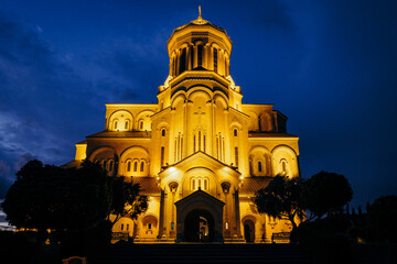 View on the Sameba cathedral and its golden dome by night in Tbilisi, Georgia