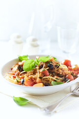 Spaghetti Pasta with Vegetables and fresh Basil on bright wooden Background.