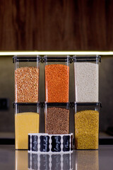 Kitchen storage organization use plastic case. Placing and sorting food products into. Keeping...
