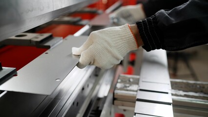 Man working with sheet metal and special machine tools for bending. Modern machines can accurately...