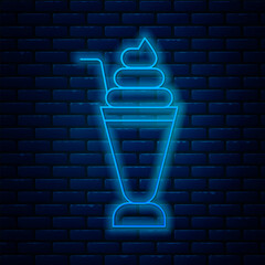 Glowing neon line Milkshake icon isolated on brick wall background. Plastic cup with lid and straw. Vector