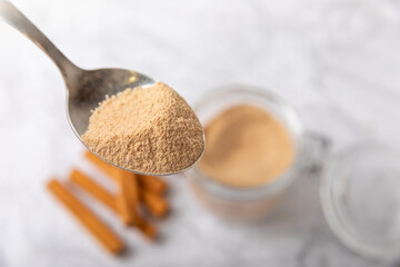 Cinnamon sugar on a texture background. Homemade cinnamon sugar in a bowl on background. Brown sugar. Spice mixture for drinks and baking. Place for text. Copy space.