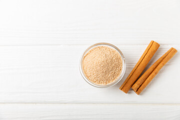 Cinnamon sugar on a texture background. Homemade cinnamon sugar in a bowl on background. Brown sugar. Spice mixture for drinks and baking. Place for text. Copy space.