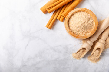 Cinnamon sugar on a texture background. Homemade cinnamon sugar in a bowl on background. Brown sugar. Spice mixture for drinks and baking. Place for text. Copy space.