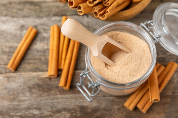 Cinnamon sugar on a texture background. Homemade cinnamon sugar in a bowl on background. Brown sugar. Spice mixture for drinks and baking. Place for text. Copy space.