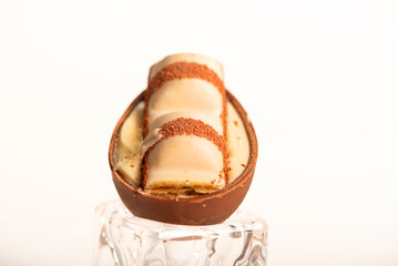 Chocolate eggs, small chocolate eggs details, white background, selective focus.