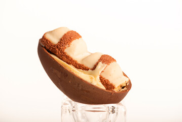 Chocolate eggs, small chocolate eggs details, white background, selective focus.