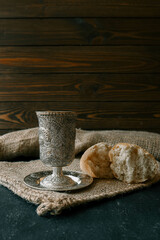 Cup with wine, bread and open Bible, Christian communion