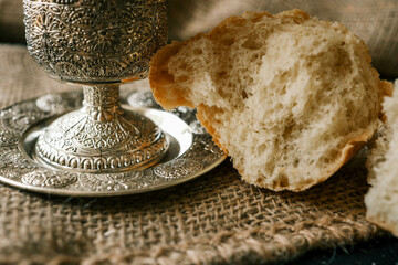 Cup with wine and bread close-up, Christian communion
