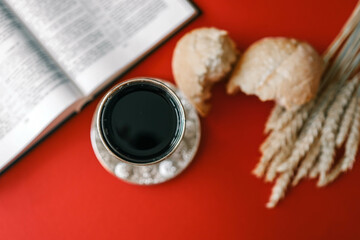 Bread and wine, communion concept on red background, top view