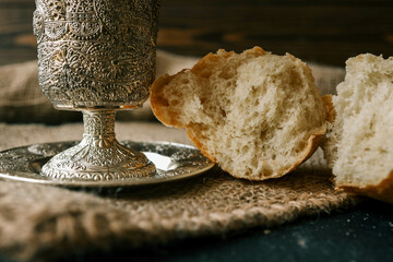 Cup with wine and bread close-up, Christian communion