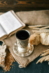 Cup with wine, bread and open Bible, Christian communion