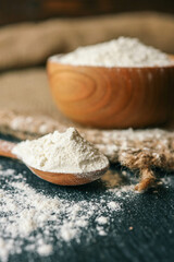 Flour in a wooden bowl on burlap