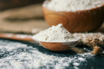 Flour in a wooden bowl on burlap