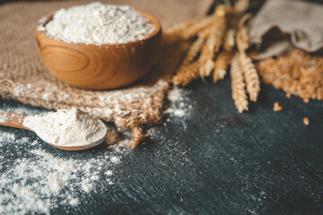 Flour in a wooden bowl, fresh homemade bread and ears of corn, bakery banner