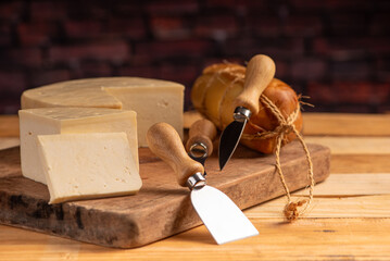 Cheese, details of beautiful and delicious cheese on rustic wooden surface, selective focus.