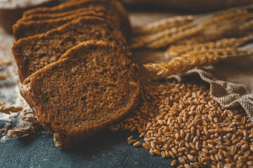 Sliced rye bread on cutting board. Whole grain rye bread with seeds