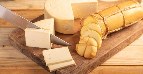 Cheese, details of beautiful and delicious cheese on rustic wooden surface, selective focus.