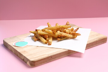 Homemade French fries on rustic wooden table