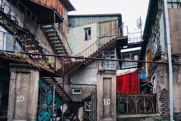 View on dilapidated houses in Tbilisi Old town (Georgia) with iron rusty staircases, balconies and...