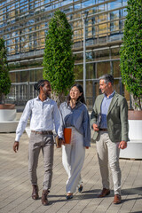 diverse ethnicity people walking together outside to the office