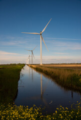 wind turbines in the field near the canal