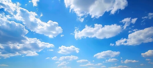 Expansive Blue Sky with Cumulus Clouds.