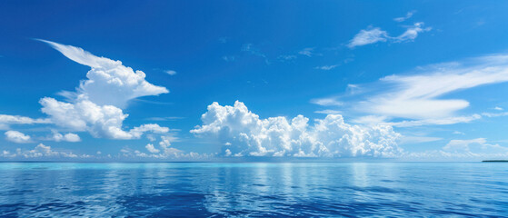 A beautiful blue sky with clouds and a calm ocean
