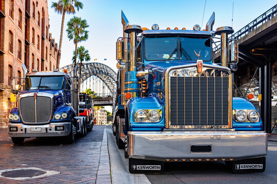 Sydney, New South Wales, Australia; February 25, 2024: Beautiful, gleaming chrome Kenworth heavy road train trucks in Sydney Harbor at Circular Quay. The Harbour Bridge can be seen in the background.