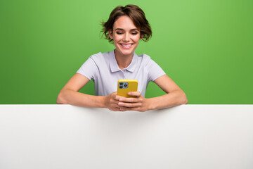 Photo of cheerful cute girl use gadget read social media instagram telegram demonstrate empty space...