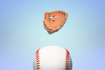 Naklejka premium Floating baseball glove above ball on blue