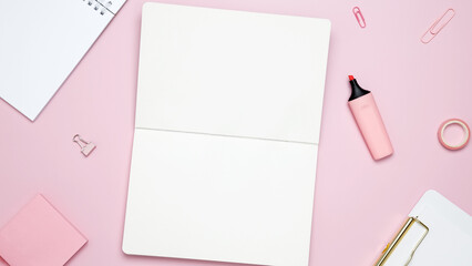 Creative flat lay mockup design of workspace. Top view composition with white notebook, to do list and stationery on pink background